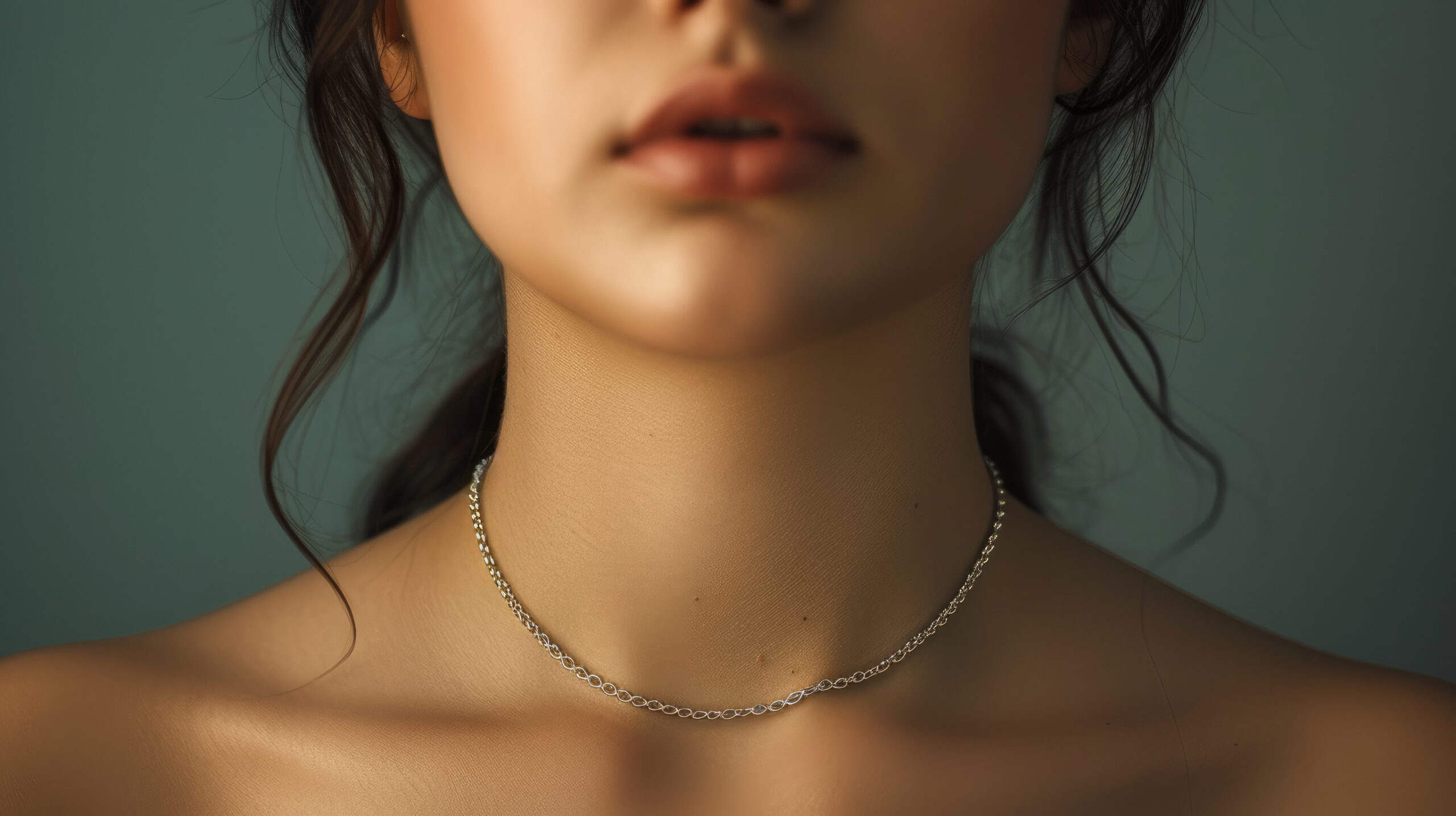 Woman wearing delicate chain necklace. Beauty concept.